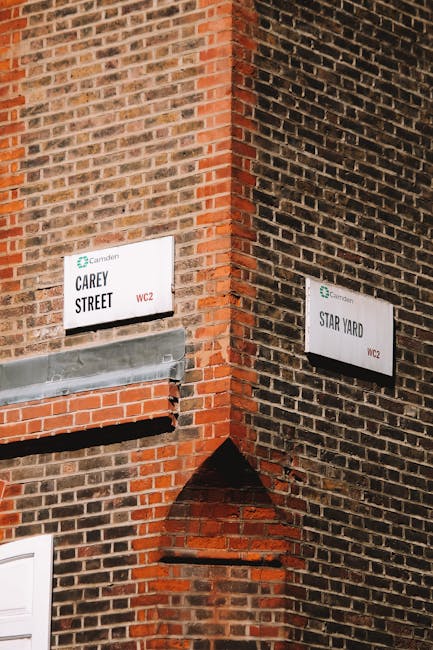 The image depicts a corner of a brick building with two street name signs mounted on the wall, indicating Carey Street and Star Yard, both in Camden Town. The brickwork shows a mix of red and dark bro
